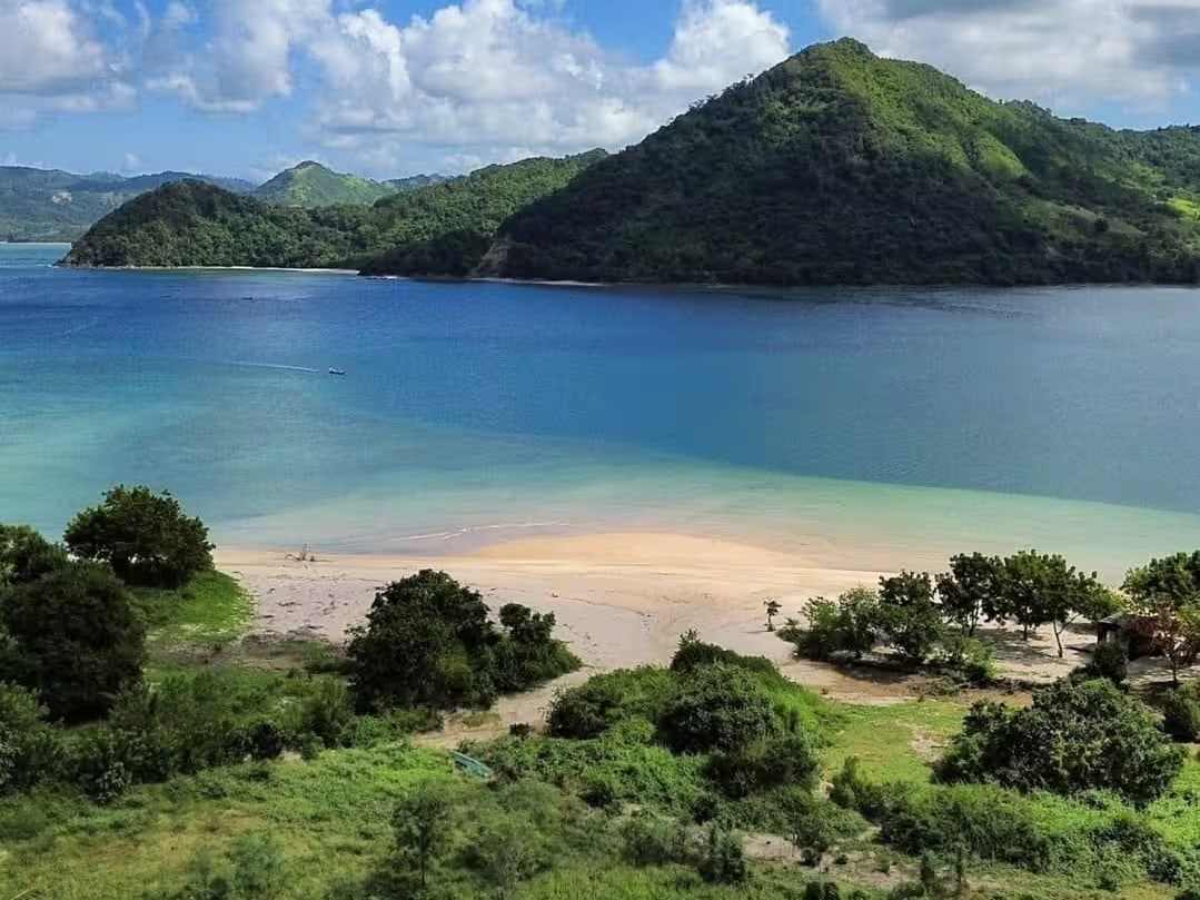 Belongas Bay in Sekotong, southwest Lombok — a calm turquoise bay framed by green hills, the planned site of Belongas Bay Marina