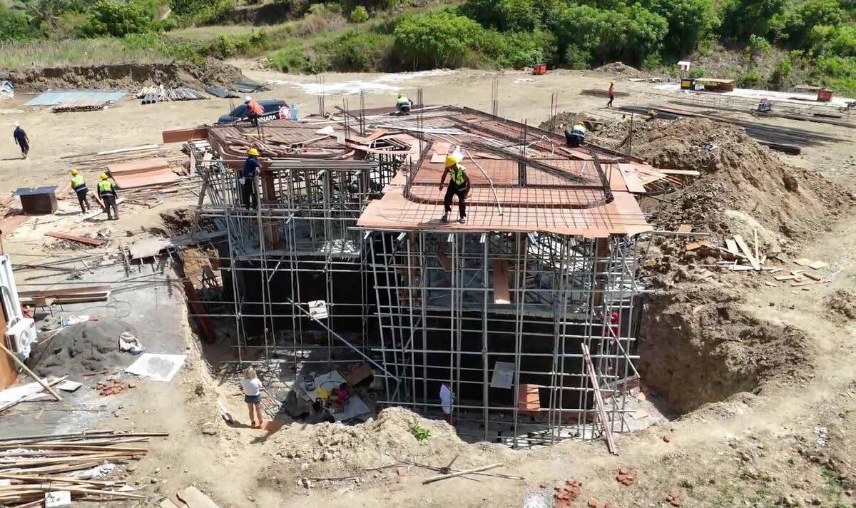 Aerial drone view of the Elysian display villa at Mandalika showing roof structure approaching completion